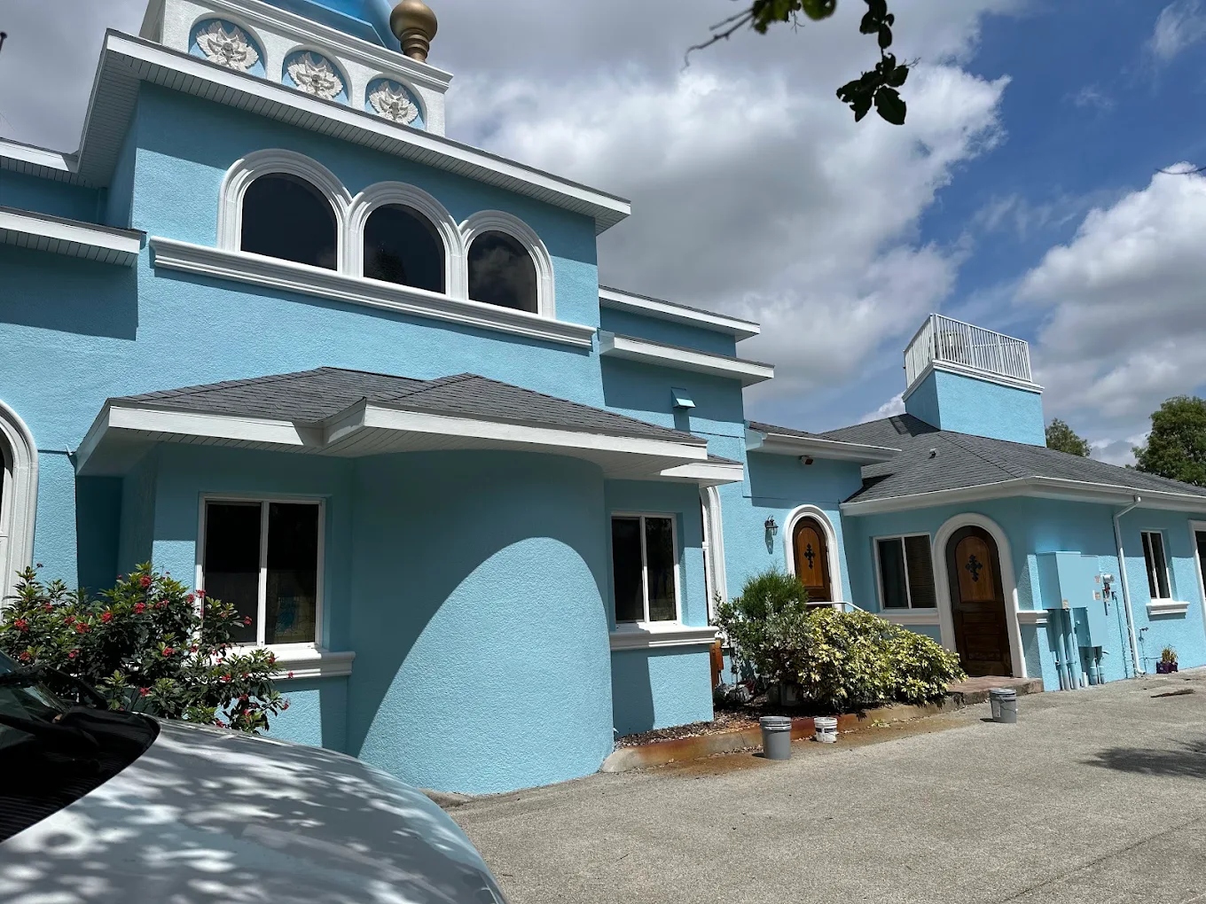 Blue church exterior with white trim and gold dome painted by Tony's Paint Solutions