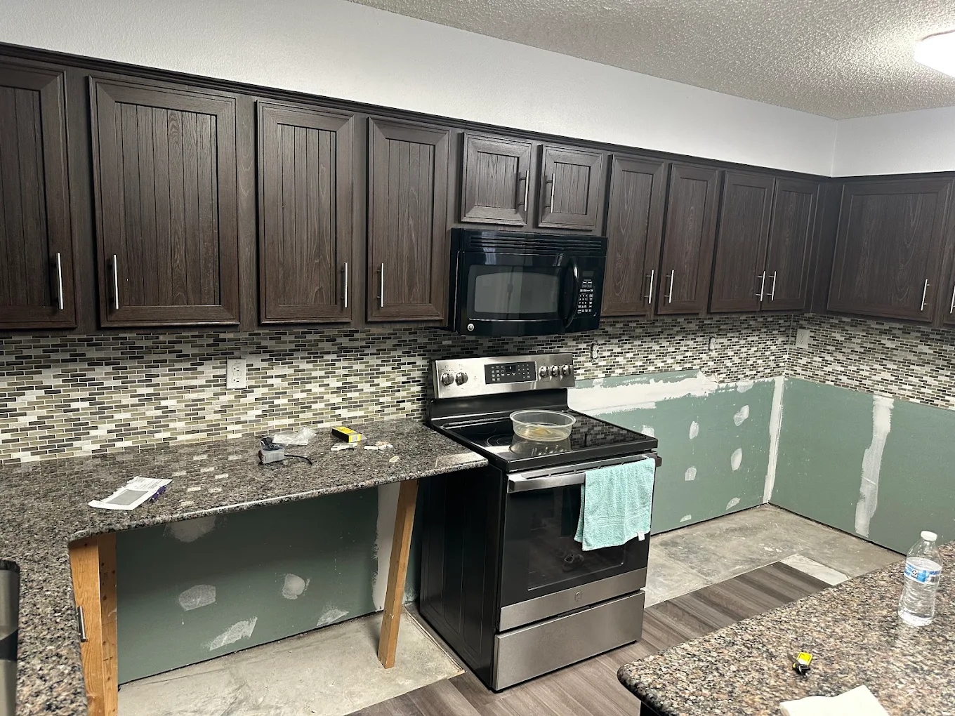 Espresso-stained kitchen cabinet refinish by Tony's Paint Solutions